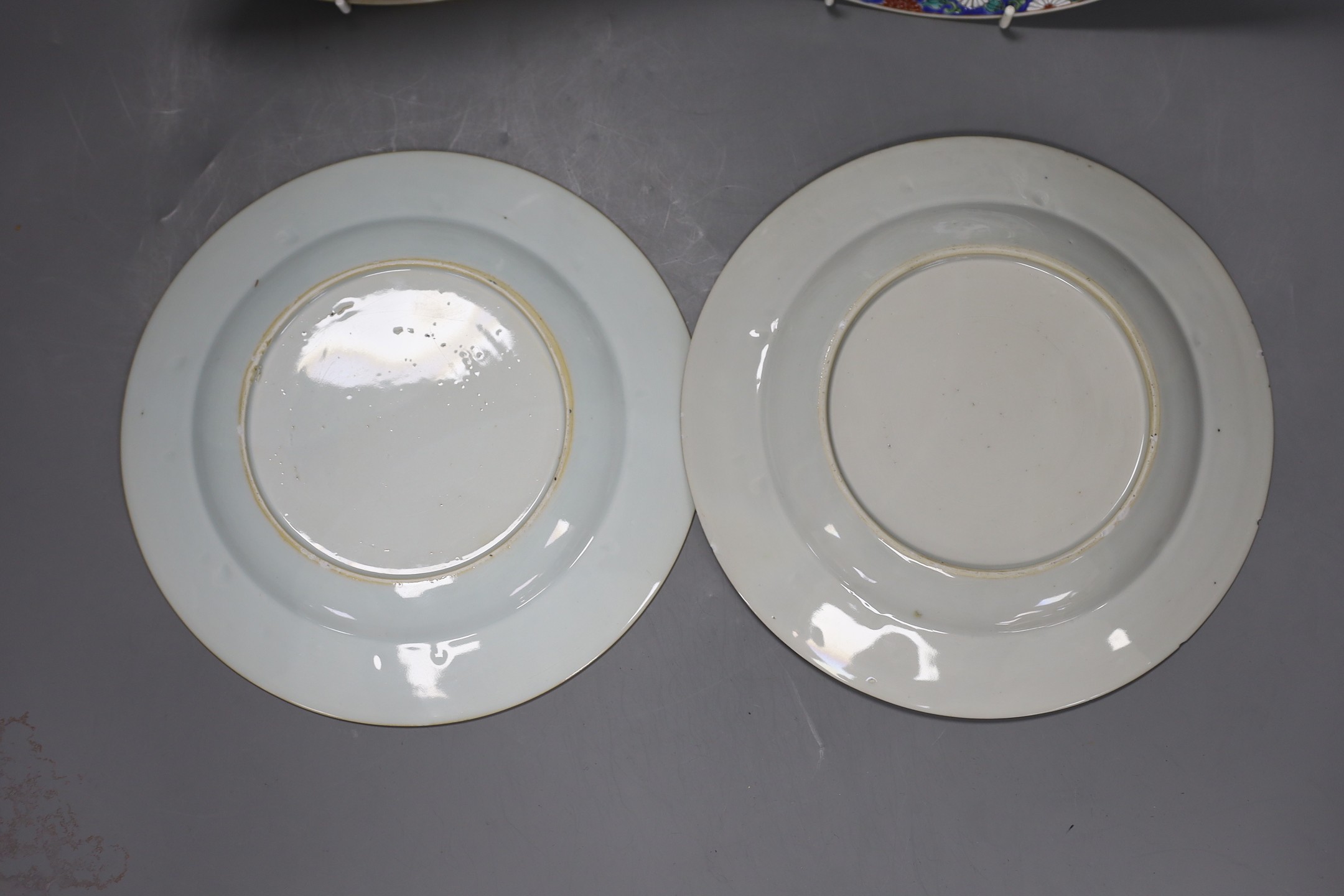 A Set of three 18th century Chinese export famille rose plates and a similar dish, largest 22.5cm diameter